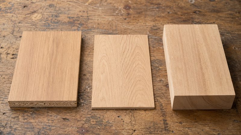 Material samples for carpentry — laminate, veneer, and solid wood finishes compared