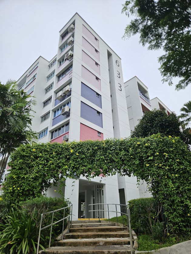 Singapore HDB block with wall-mounted aircon units — servicing requirements differ from condo setups